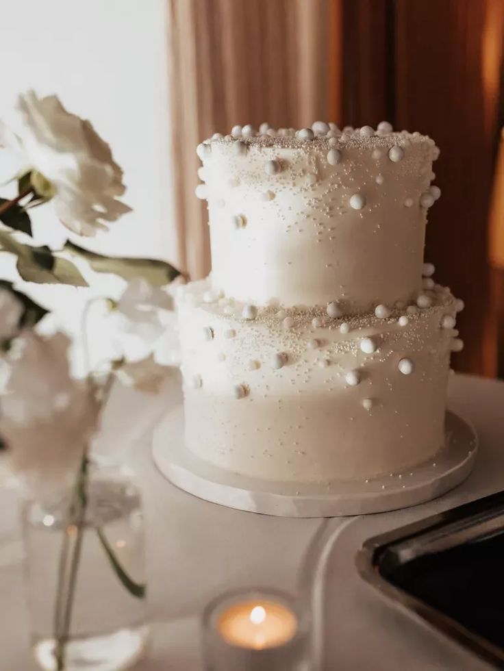 a white wedding cake sitting on top of a table