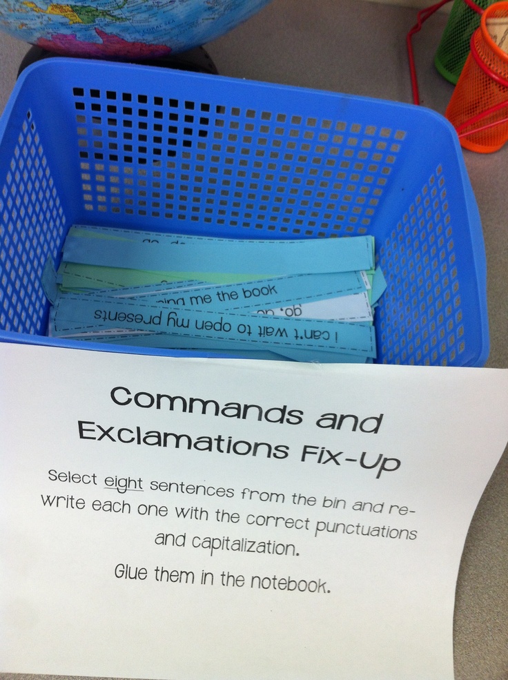 a close up of a sign near a basket with papers in it on a table