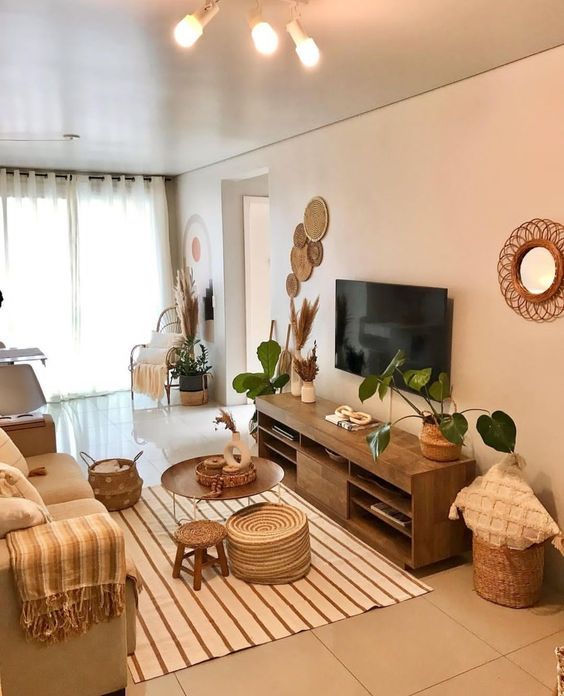 a living room filled with furniture and a flat screen tv on top of a wooden stand