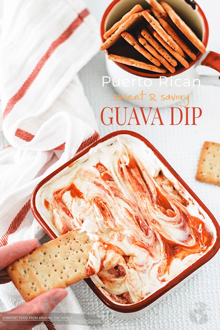 a person dipping crackers into a bowl of guava dip