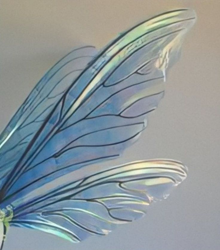 a glass sculpture of a blue bird with long wings