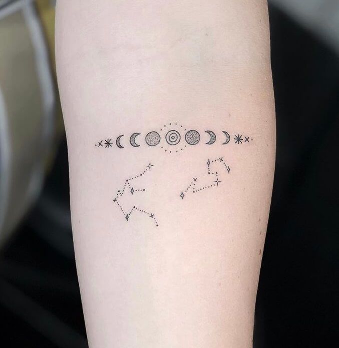 a person with a tattoo on their arm that shows the phases of the moon and stars