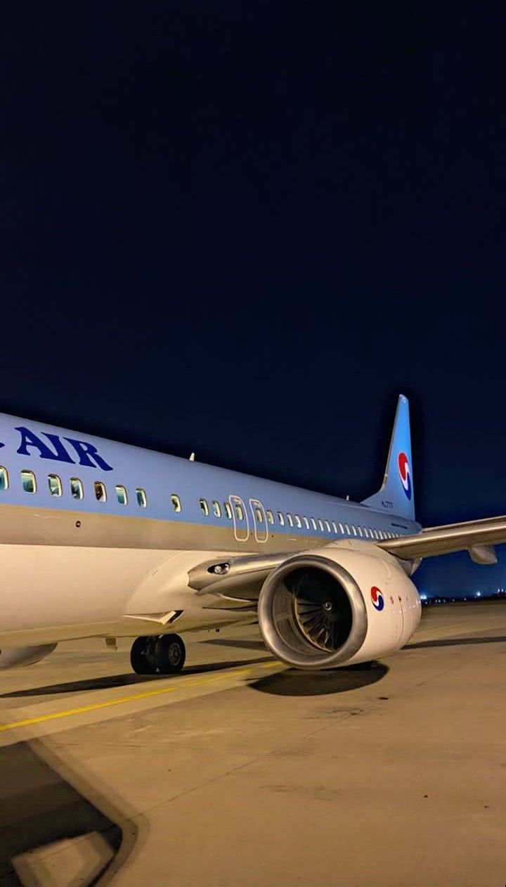 an airplane sitting on the tarmac at night