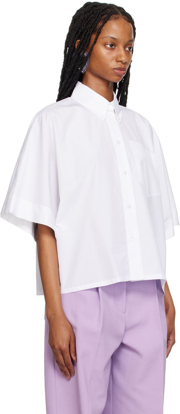 Cotton poplin shirt. · Button-down spread collar · Button closure · Patch pocket · Dropped shoulders · Crystal-cut appliqué at back collar Supplier color: White Cotton Poplin Shirt, Shirt Button, Poplin Shirt, White Shop, Luxury Streetwear, Cotton Poplin, Drop Shoulder, Patch Pocket, Designer Fashion