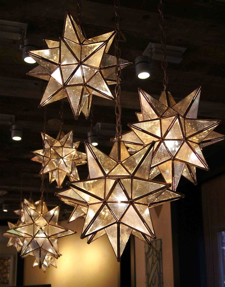 a chandelier made out of paper stars hanging from the ceiling