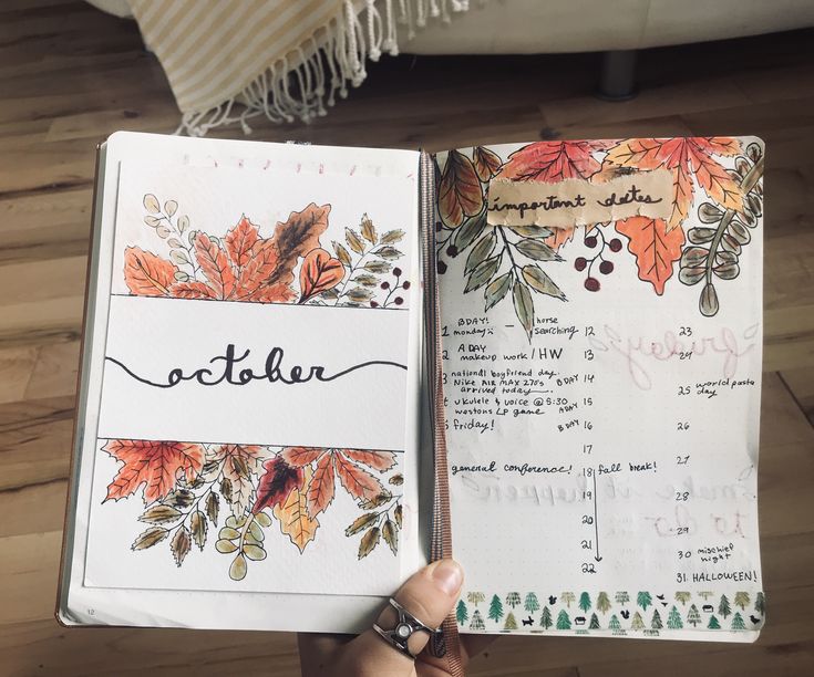 an open notebook with the word october written on it and autumn leaves painted in black ink