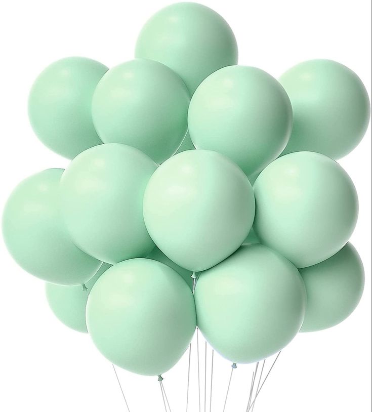 a bunch of green balloons floating in the air