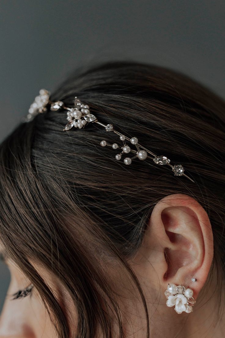 a close up of a woman wearing a head piece with pearls and beads on it