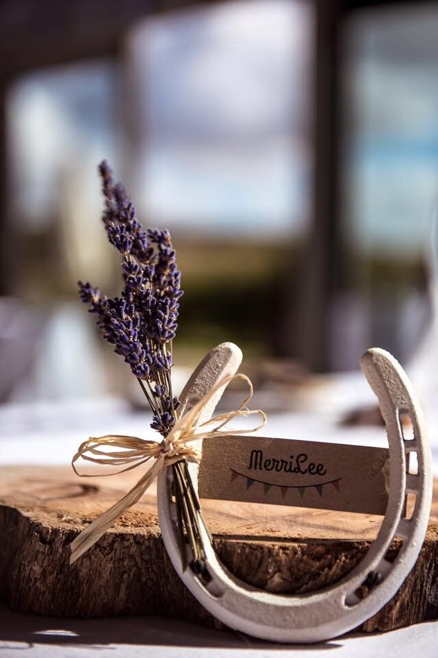 a wooden table topped with a piece of wood and a small lavender plant on top of it