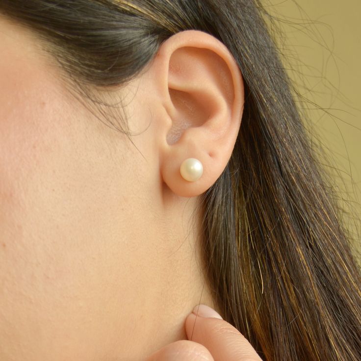 Experience the elegance and delicacy of our beautiful Pearl Stud Earrings. Each earring is crafted with Natural Freshwater Pearls and set on 14k gold plated sterling silver, making them perfect for sensitive skin. The versatile style adds a classic and elegant touch to any occasion, and they are particularly ideal for a bride on her wedding day. Handmade in the U.S.A Sold in pairDETAILSWater Resistant- skin-friendly-Tarnish-free Material: Sterling Silver, 14k gold plated Natural freshwater pearl Classic Sterling Silver Clip-on Earrings, Classic Everyday Pearl Drop Jewelry, Elegant Everyday Round Clip-on Earrings, Elegant Hypoallergenic Earrings For Formal Occasions, Elegant Hypoallergenic Earrings For Formal Events, Classic Hypoallergenic Sterling Silver Jewelry, Hypoallergenic Classic Sterling Silver Jewelry, Classic White Gold Hypoallergenic Pearl Earrings, Classic Hypoallergenic White Gold Pearl Earrings