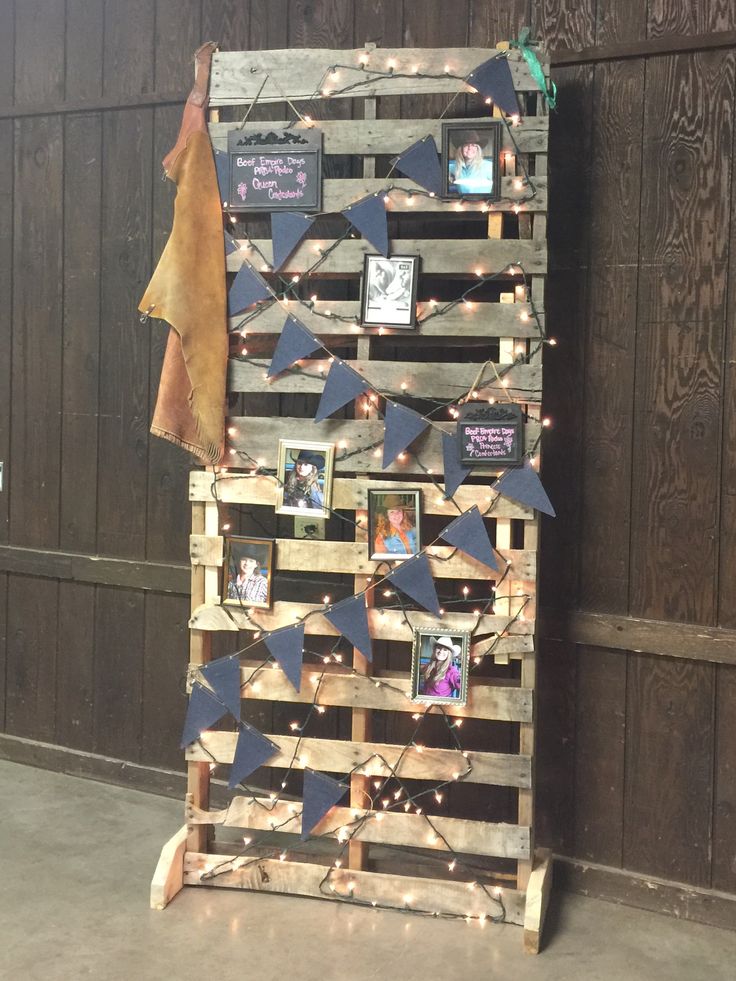 a wooden pallet with pictures and lights on it