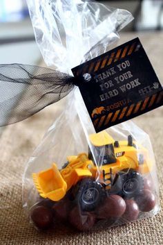 a plastic bag filled with chocolate covered construction vehicles