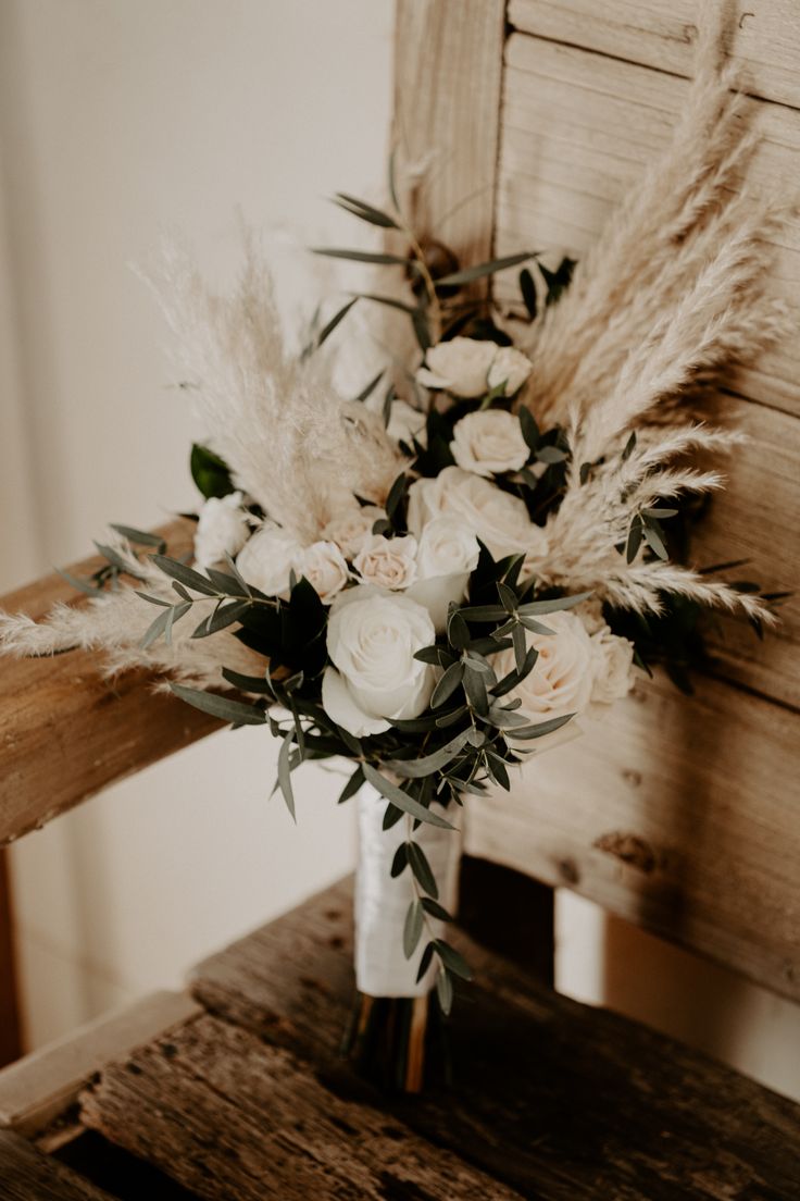 a bouquet of flowers sitting on top of a wooden table