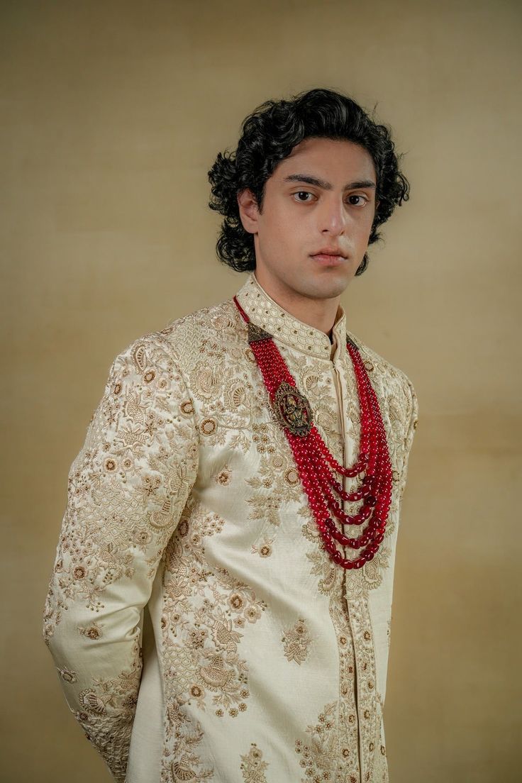 Butter Cream Sherwani | Jatin Malik Introducing our exquisite dirty ivory sherwani, a true work of art. This sherwani is intricately hand-embroidered with traditional chikankari motifs and embellishments, paying tribute to the time-honored art form. The meticulous craftsmanship highlights the rich heritage and cultural significance of chikankari, making this sherwani a perfect blend of elegance and tradition. Ideal for making a sophisticated statement, this ensemble embodies the essence of timeless artistry. Included in purchase: Sherwani, Kurta, Churidar Product Specification Color: Dirty Ivory Fabric: Linen silk Occasion: Engagement, Wedding, Bridal, Reception Style: Sherwani, Kurta, Churidar Care: Dry Clean Work: Hand Embroidery Customization options:Can be customized in any color or st Traditional Raw Silk Bandhgala With Chikankari Embroidery, Traditional Naqshi Kurta For Reception, Ceremonial Cream Bandhgala With Chikankari Embroidery, Traditional Nehru Jacket For Diwali Reception, Traditional Cream Kurta With Naqshi Detailing, Festive Cream Sherwani With Naqshi Detailing, Traditional Cream Kurta With Naqshi Embroidery, Ceremonial Cream Sherwani With Traditional Drape, Traditional Raw Silk Wear With Naqshi Detailing