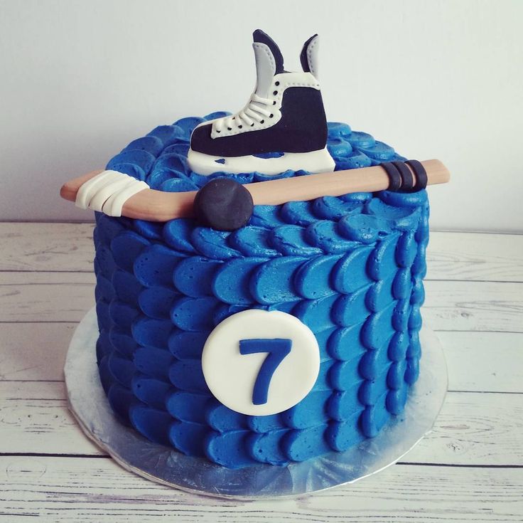 there is a cake that has a figure on it and a hockey stick in the middle