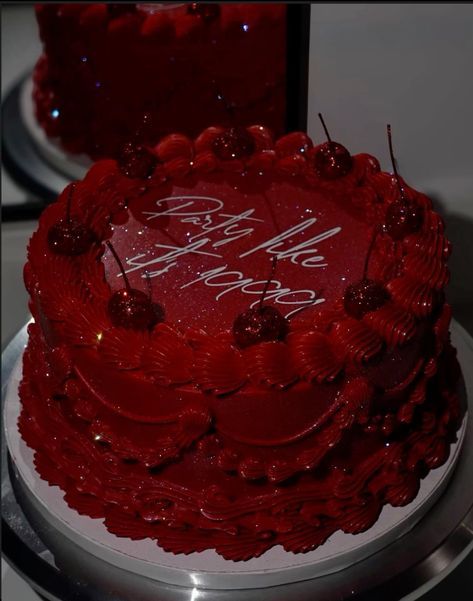 a red frosted cake sitting on top of a table