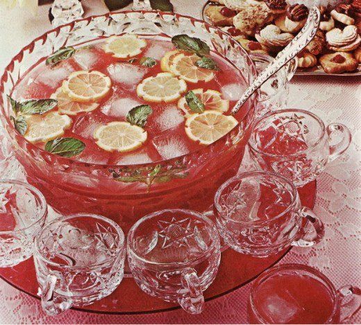 an old fashioned dish with lemons and watermelon garnish on it