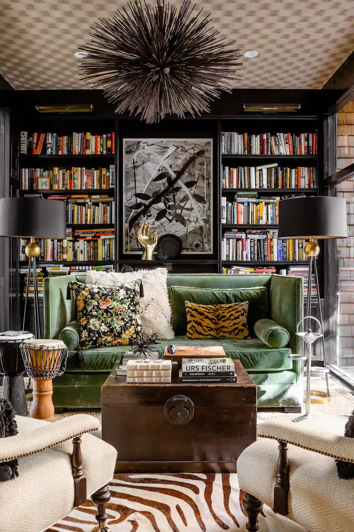 a living room filled with furniture and lots of books