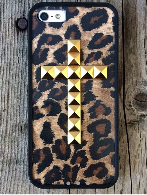 a leopard print phone case with gold studded cross on the front and back cover