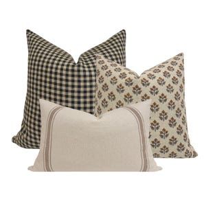 four pillows with different patterns on them, one in black and the other in white