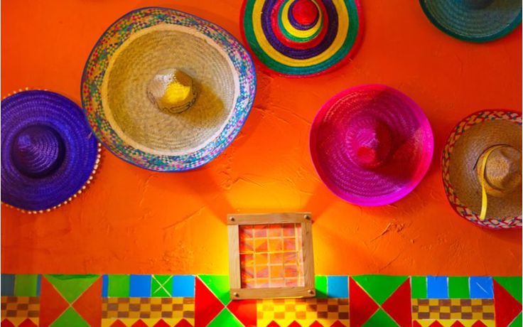 colorful hats are hanging on the wall