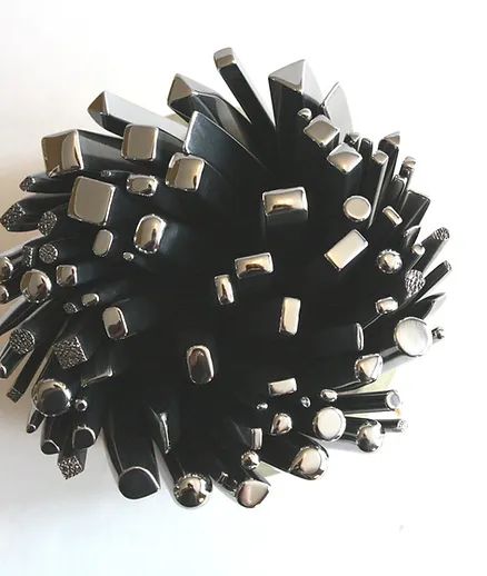 a bunch of black and silver objects on a white surface