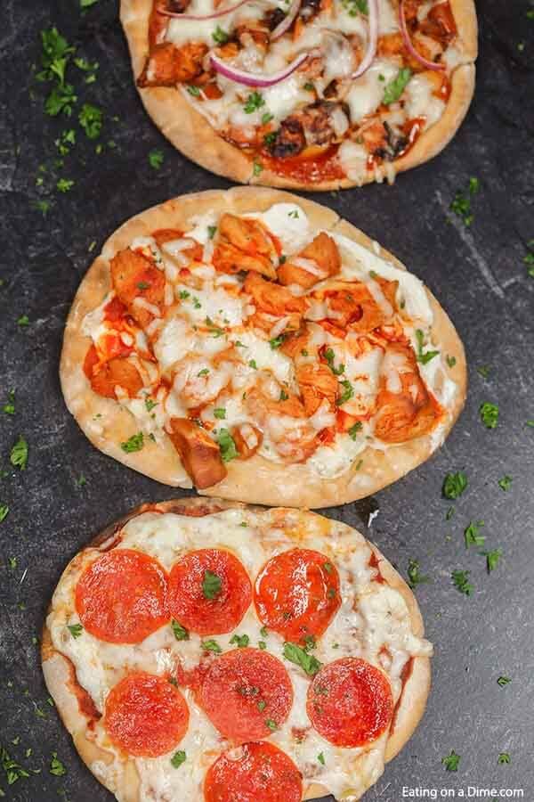 three pizzas with different toppings sitting on a table