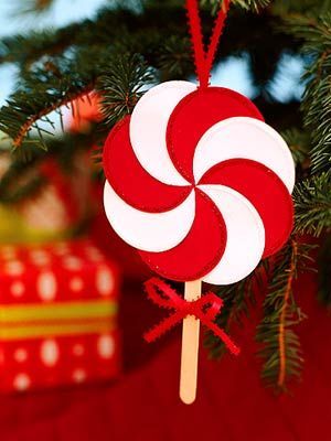 a lollipop ornament hanging from a christmas tree