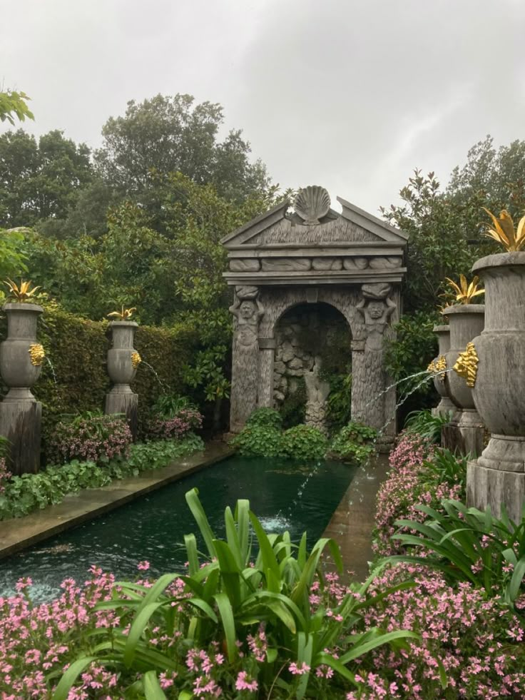 an outdoor garden with water and flowers