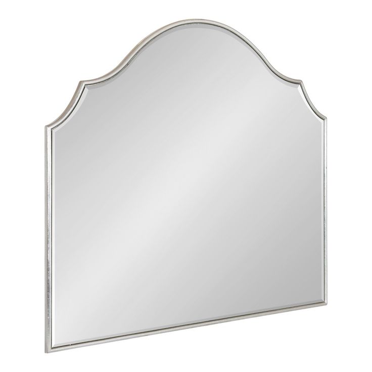 a mirror that is sitting on top of a wall mounted shelf with a white frame