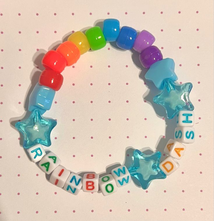 a rainbow bracelet with stars and words on it