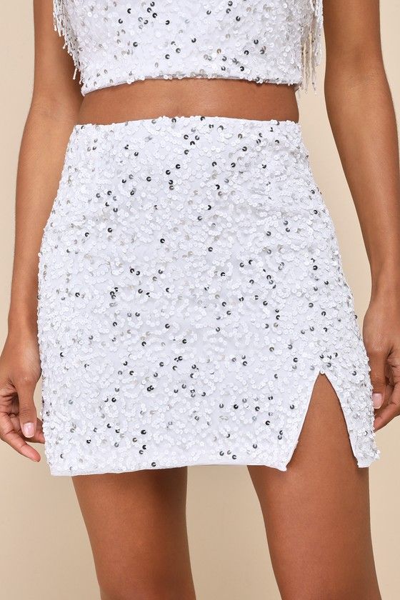 The party is here! The Lulus Glam of the Moment White Beaded Sequin Mini Skirt will outshine everyone with its shiny white and silver beads and sequins that dazzle across a mesh overlay (atop a white knit lining) that forms a high waist, an A-line silhouette, and a notched, mini hem. Hidden back zipper/clasp. Pair with the matching top for a complete look! Fit: This garment fits true to size. Length: Mid-thigh. Size medium measures 15.5" from waist to hem. Waist: Fitted - very fitted at natural Elegant Summer Bottoms With Contrast Sequin, Sequin Skirt For Wedding, Summer Silver Sequined Mini Skirt, Fitted Silver Sequined Mini Skirt, Glamorous White Bottoms For Night Out, Fitted Sequin Skirt For Prom, Sequin Skirt For Wedding And Party Season, Glamorous Sequined Wedding Skirt, Wedding Skirt With Sequins For Party Season