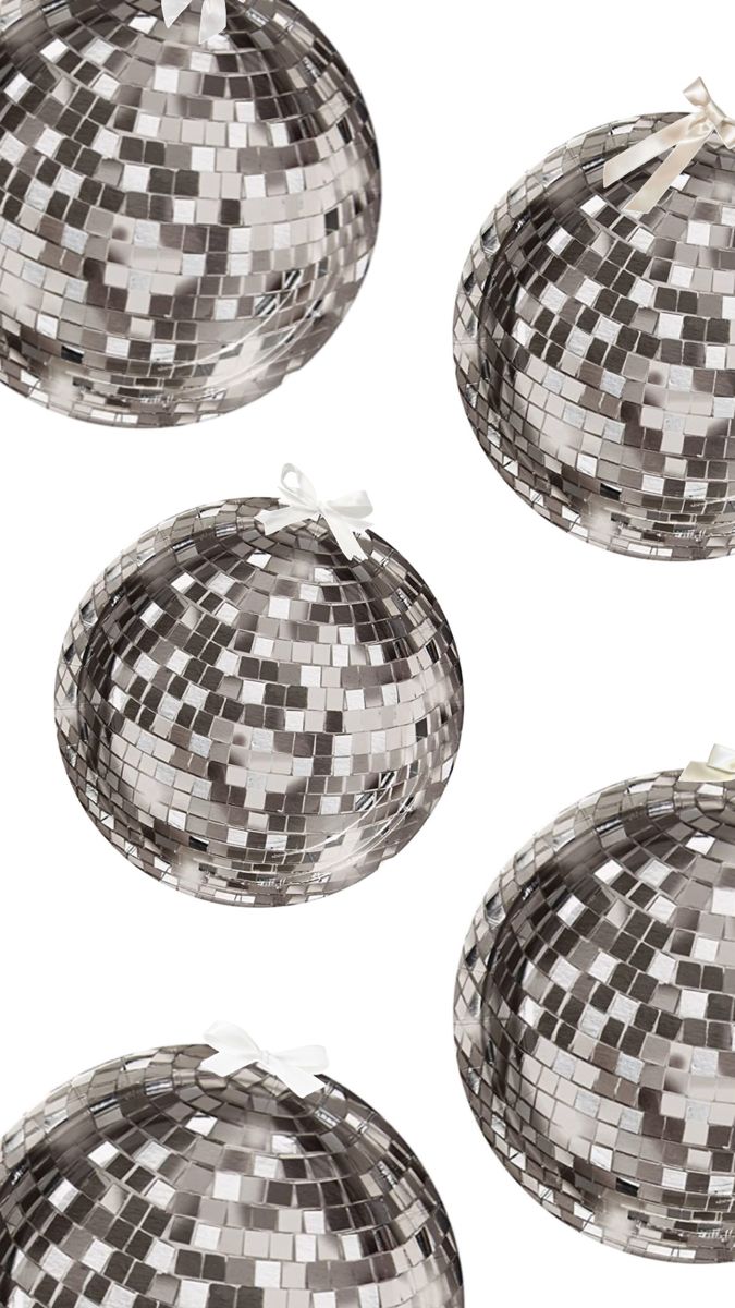 four silver disco ball ornaments on white background