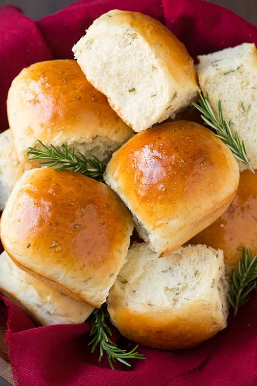 rolls with rosemary sprigs in a red bowl