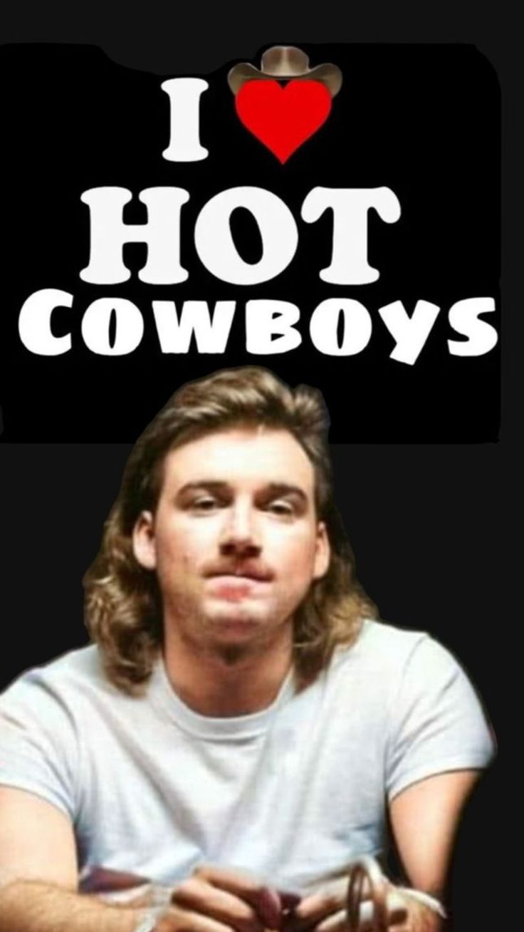 a man with long hair is looking at the camera and has i love hot cowboys sticker on his shirt