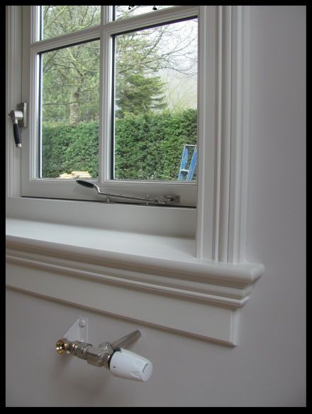 a white window sill sitting next to a window