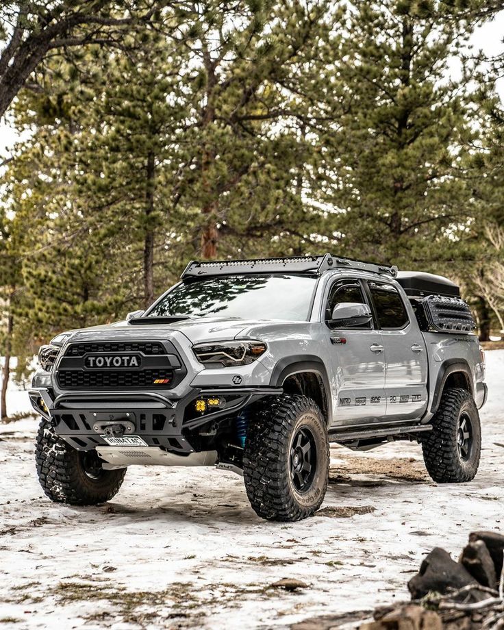 a gray toyota truck parked in the snow