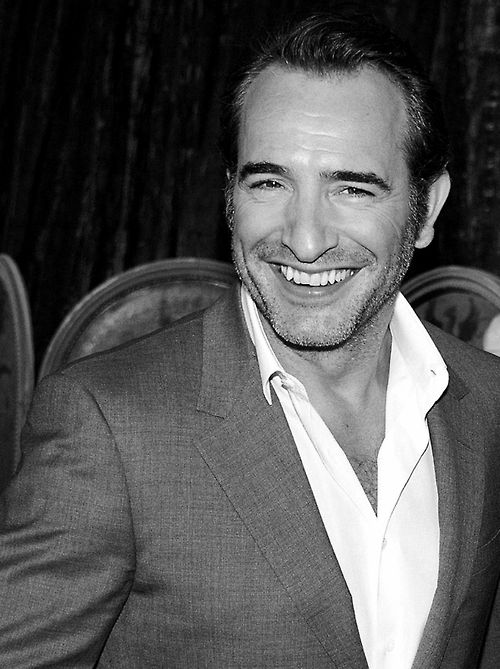 a black and white photo of a smiling man