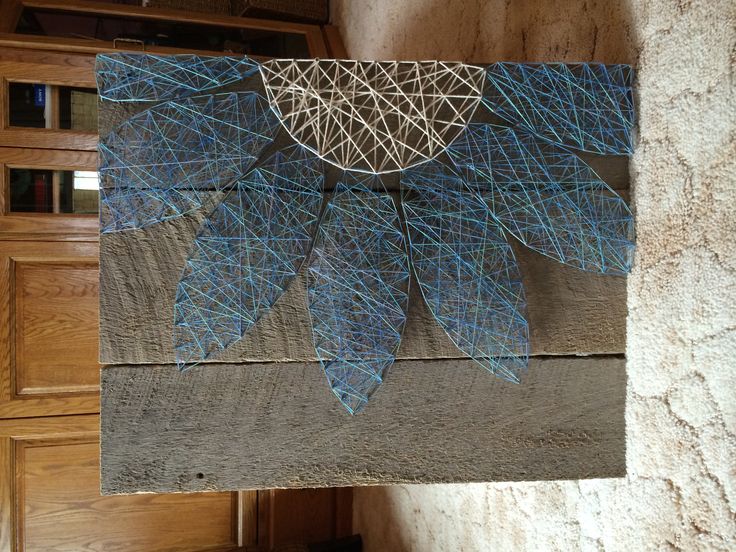 a piece of wood with blue leaves on it