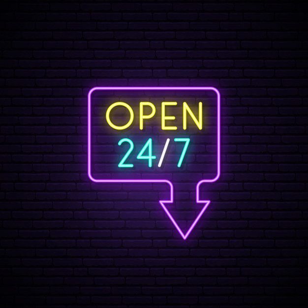 neon open sign with arrow on brick wall