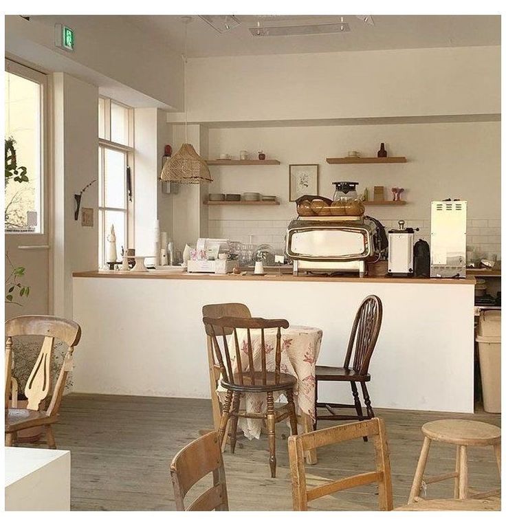 a kitchen filled with lots of wooden chairs