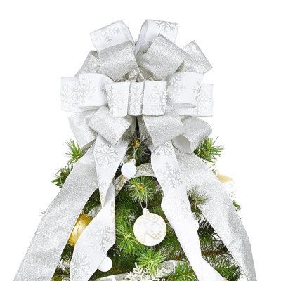 a christmas tree with white bows and ornaments