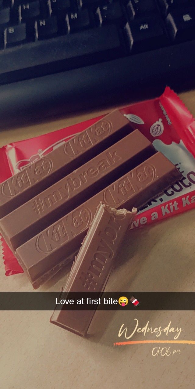 some chocolate bars sitting on top of a desk next to a keyboard