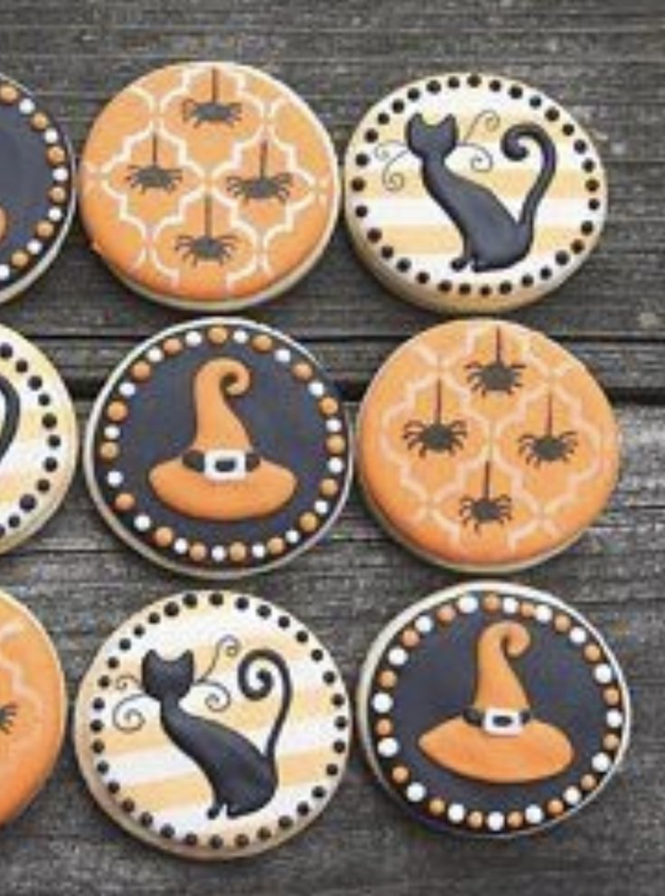 decorated cookies with black cats and witches on them are arranged in the shape of pumpkins