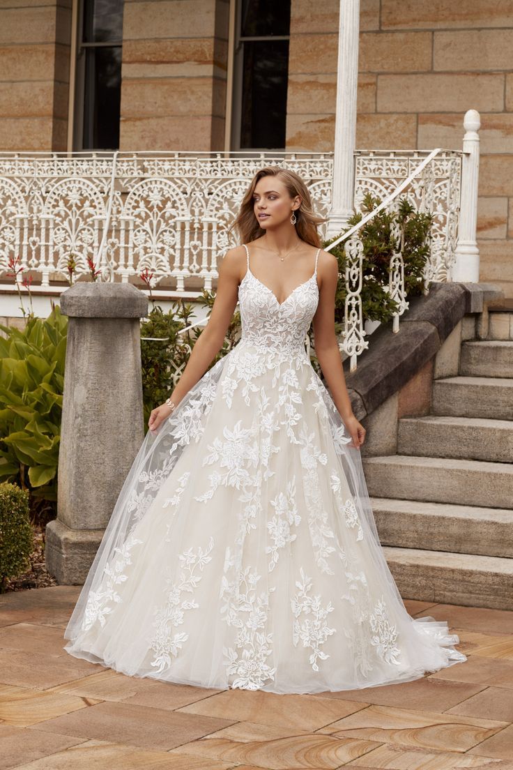 a woman in a wedding dress standing on steps