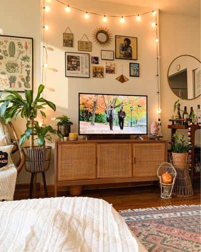 a flat screen tv sitting on top of a wooden dresser