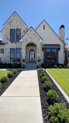 a large house with lots of windows and landscaping