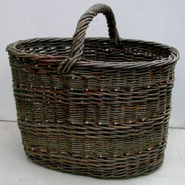 an empty wicker basket sitting on the floor