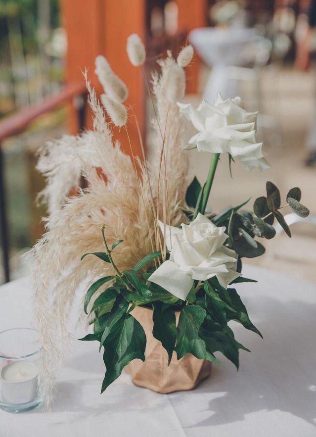 a vase filled with white flowers sitting on top of a table