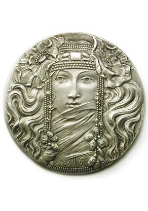 a silver coin with a woman's face on it